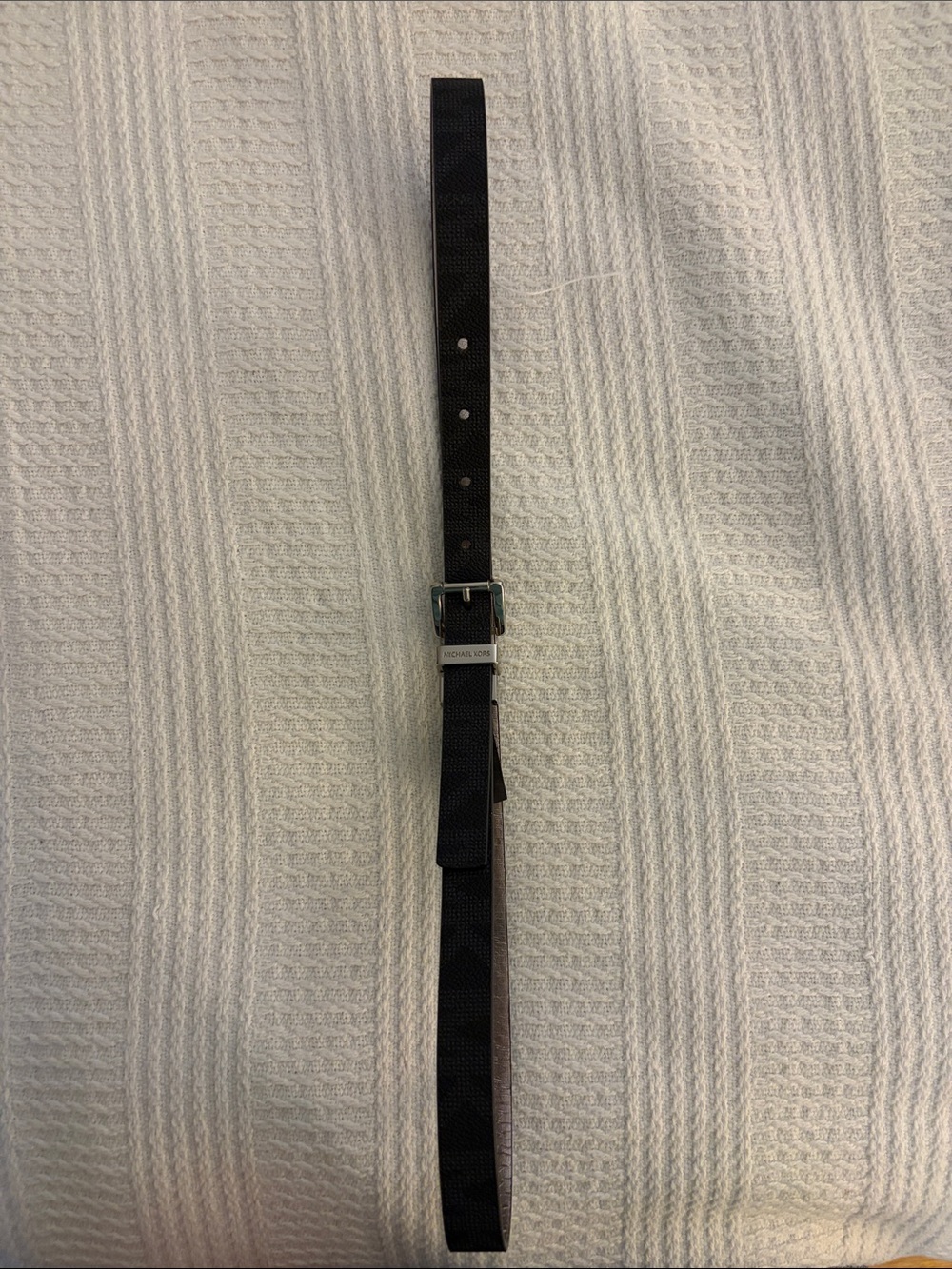 Women’s reversible black/sliver Michael Kors belt.